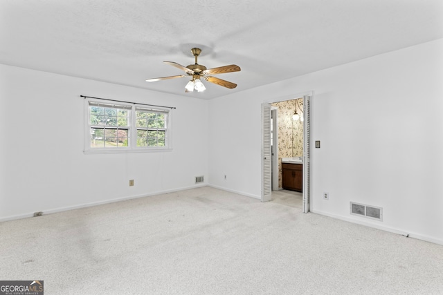 unfurnished room with light carpet and ceiling fan