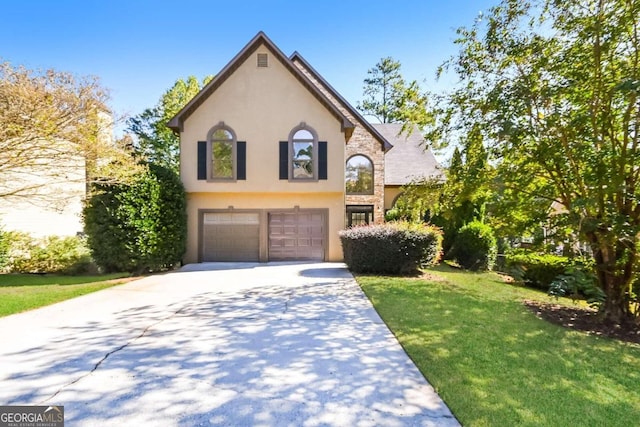 view of front of property with a front yard and a garage