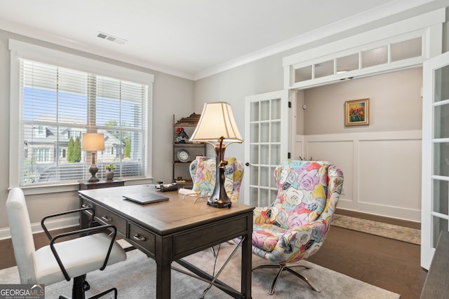 office space with french doors, crown molding, visible vents, wood finished floors, and a decorative wall