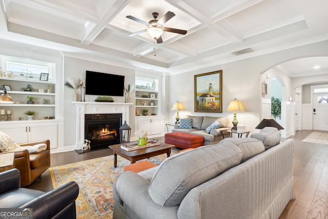 living room with ornamental molding, coffered ceiling, plenty of natural light, and dark hardwood / wood-style flooring