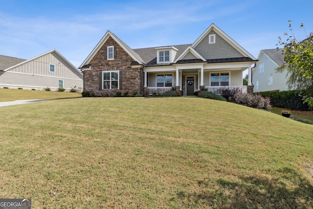 craftsman inspired home with a porch, stone siding, and a front yard