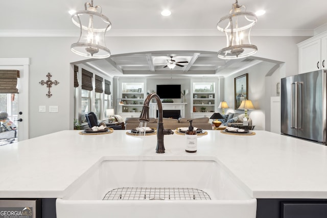 kitchen featuring open floor plan, a ceiling fan, high quality fridge, and a sink