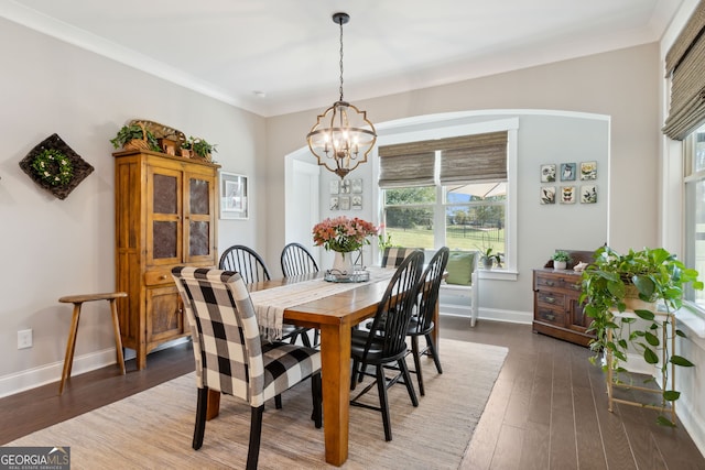 dining area with plenty of natural light, baseboards, a notable chandelier, and wood-type flooring