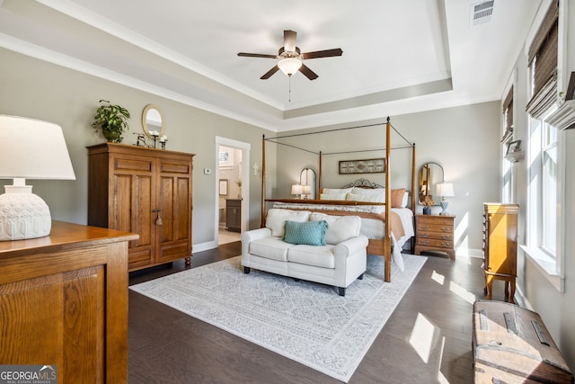 bedroom featuring connected bathroom, ceiling fan, a raised ceiling, and dark hardwood / wood-style floors