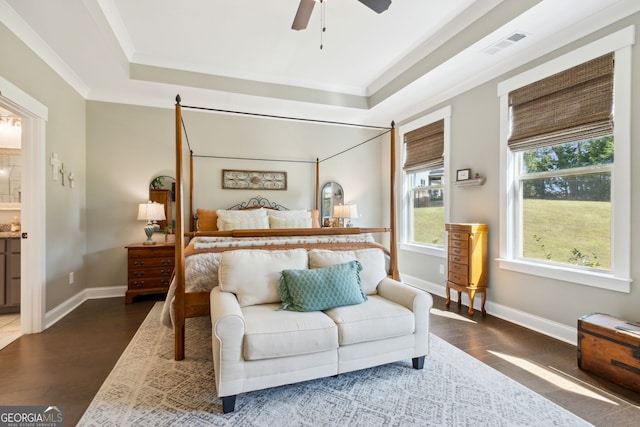 bedroom featuring dark hardwood / wood-style flooring, crown molding, a raised ceiling, and ceiling fan