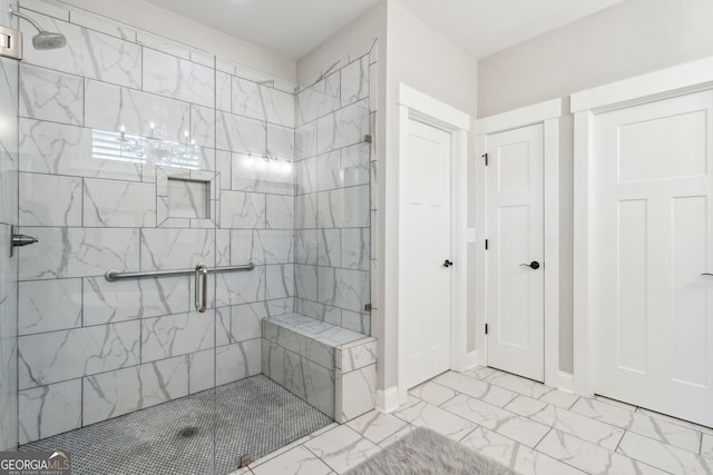 full bathroom featuring a shower stall, marble finish floor, and baseboards