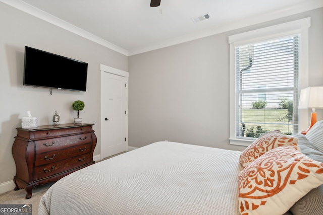 carpeted bedroom featuring crown molding, multiple windows, and ceiling fan