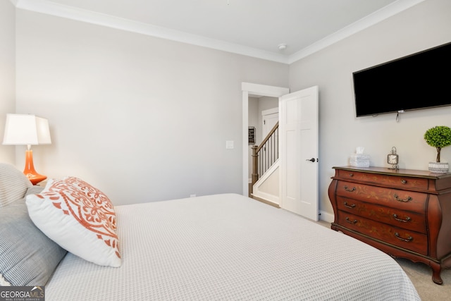 carpeted bedroom with ornamental molding