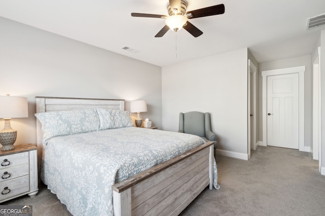 carpeted bedroom with visible vents, a ceiling fan, and baseboards