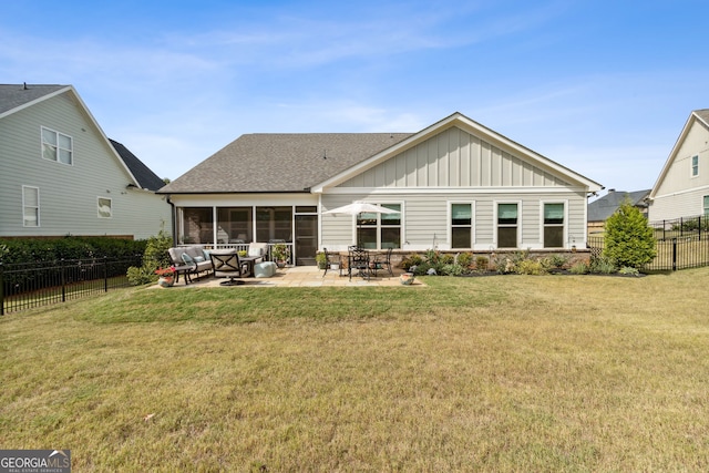 back of property featuring a yard, a patio, and a sunroom