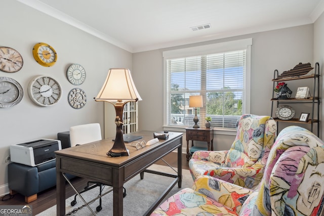 office space featuring wood finished floors, visible vents, and crown molding