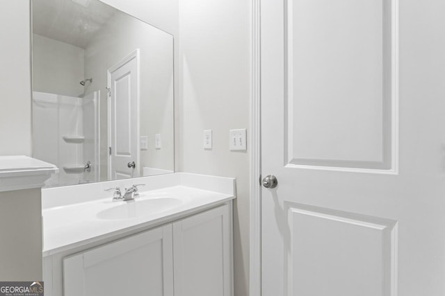 bathroom with walk in shower and vanity