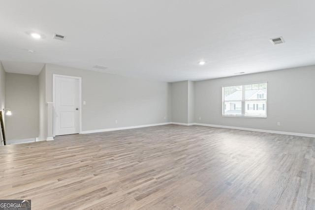 interior space with light wood-style flooring, visible vents, and baseboards