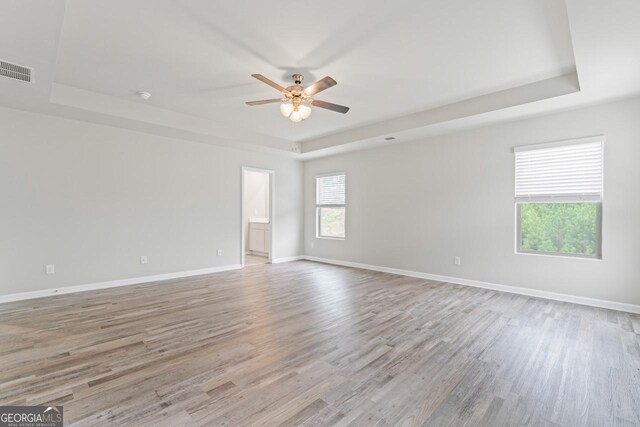 unfurnished bedroom featuring a walk in closet, light hardwood / wood-style floors, and a closet