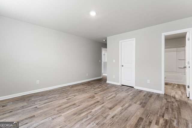 unfurnished bedroom featuring light wood finished floors and baseboards