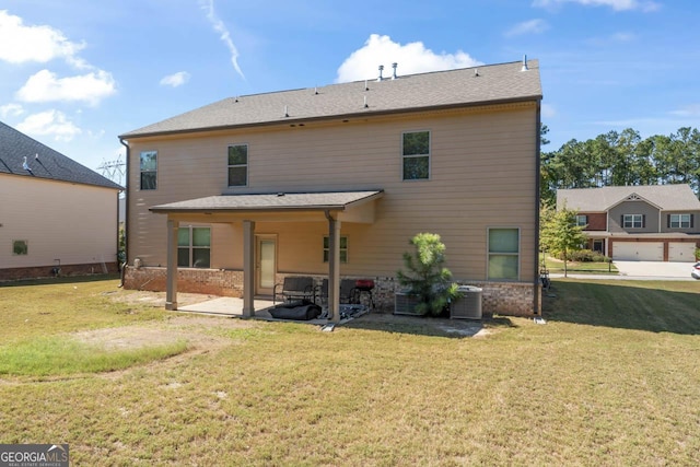 rear view of property featuring cooling unit, a yard, and a patio