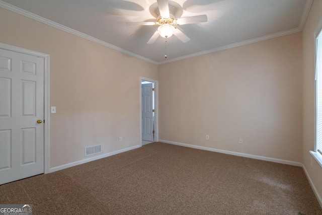 spare room featuring ornamental molding, carpet flooring, and ceiling fan