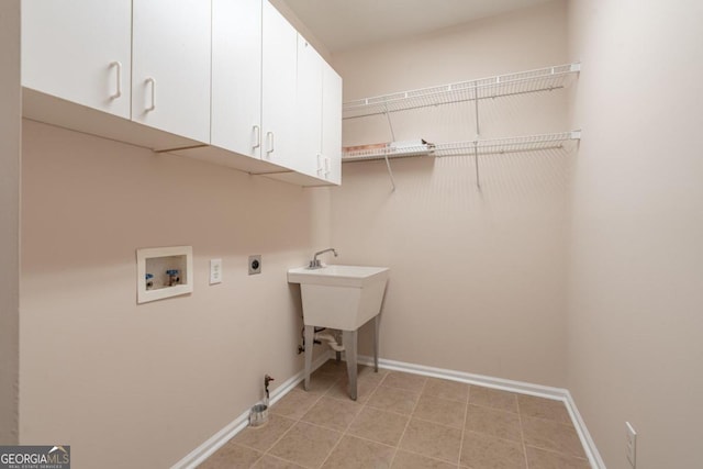 clothes washing area featuring cabinets, hookup for an electric dryer, and hookup for a washing machine