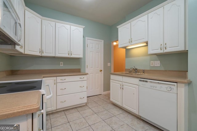 kitchen featuring white cabinets, sink, light tile patterned floors, and white appliances