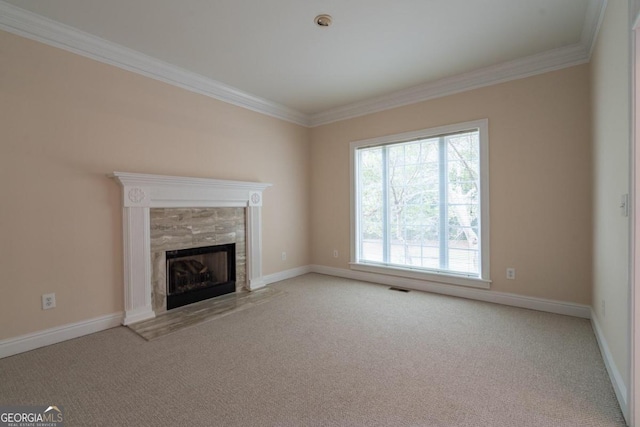 unfurnished living room with ornamental molding, light carpet, and a tile fireplace