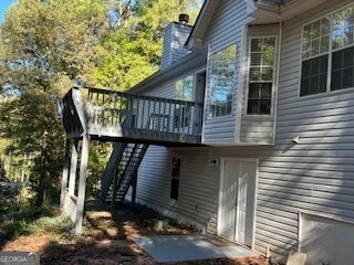 view of side of home featuring a wooden deck