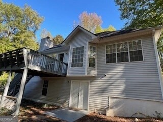 back of house featuring a deck