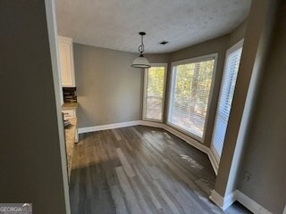 unfurnished dining area with hardwood / wood-style floors