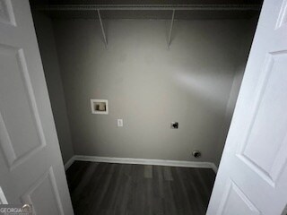 clothes washing area featuring hookup for an electric dryer, washer hookup, and dark hardwood / wood-style flooring