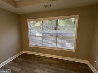 spare room with dark hardwood / wood-style flooring