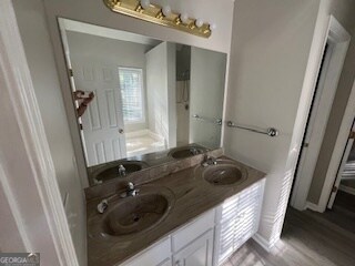 bathroom with vanity and hardwood / wood-style flooring