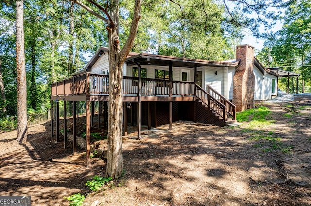 back of property with a wooden deck