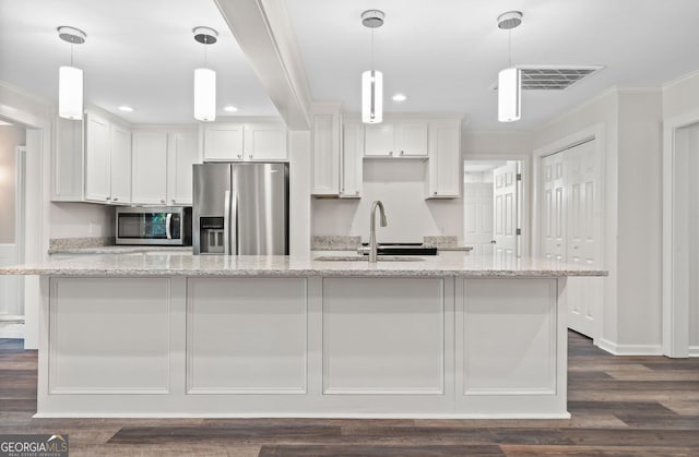 kitchen with white cabinets, appliances with stainless steel finishes, and light stone counters