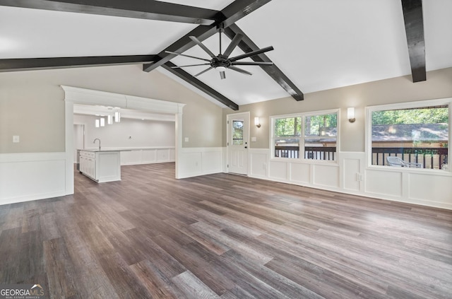 unfurnished living room featuring lofted ceiling with beams, ceiling fan, sink, and wood-type flooring