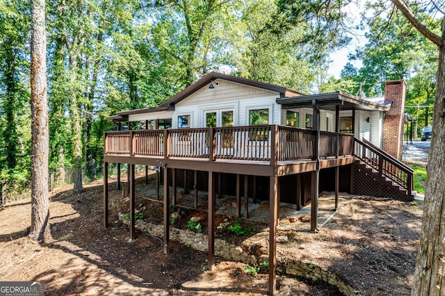 back of house with a wooden deck