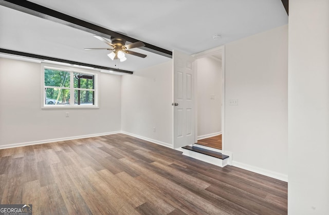 spare room with hardwood / wood-style flooring, ceiling fan, and beamed ceiling