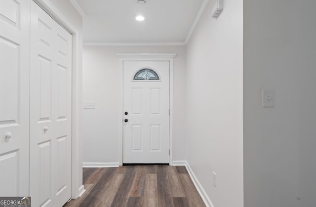 doorway with crown molding and dark hardwood / wood-style floors