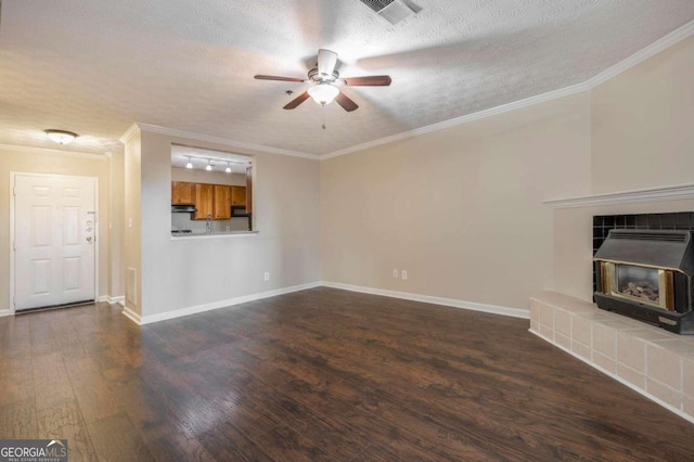 unfurnished living room with dark wood-type flooring, ceiling fan, a textured ceiling, and ornamental molding