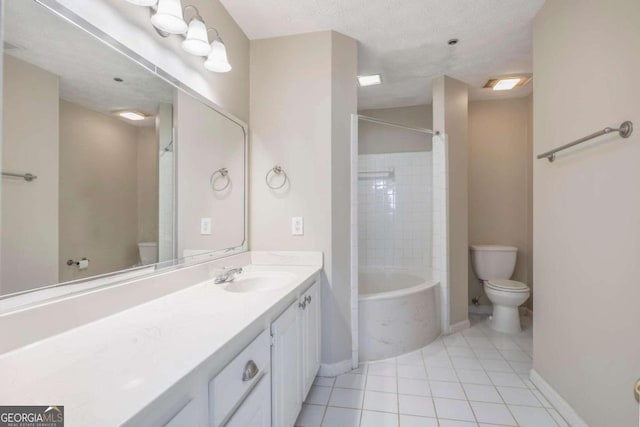 full bathroom featuring a textured ceiling, toilet, vanity, tiled shower / bath combo, and tile patterned flooring