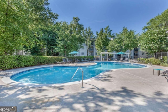 view of swimming pool with a patio