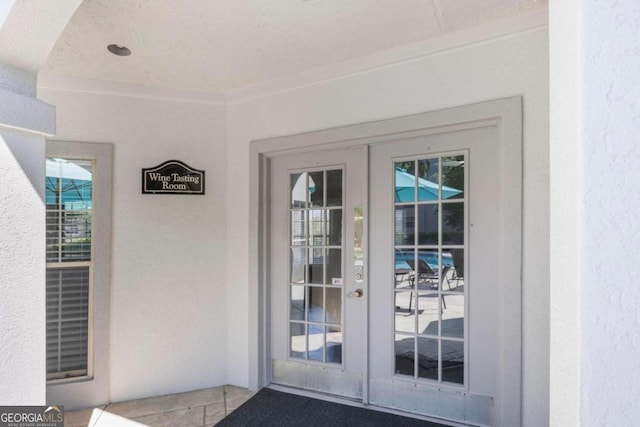 doorway with french doors and ornamental molding