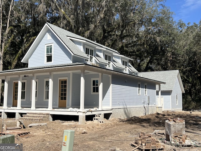 exterior space featuring a porch and a shingled roof