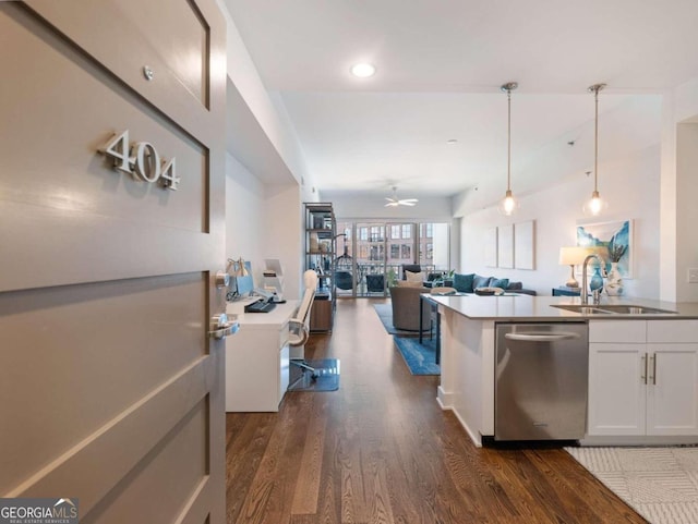 kitchen with dishwasher, dark hardwood / wood-style floors, hanging light fixtures, sink, and white cabinetry