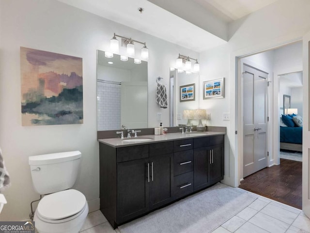 bathroom featuring vanity, hardwood / wood-style flooring, toilet, and walk in shower