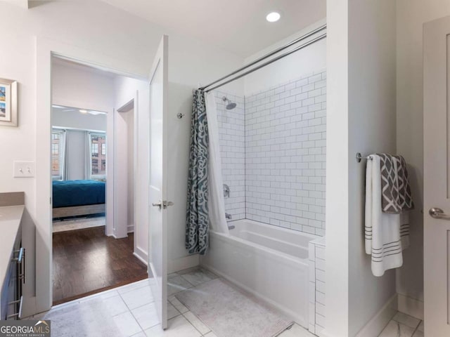 bathroom featuring shower / bath combination with curtain, wood-type flooring, and vanity