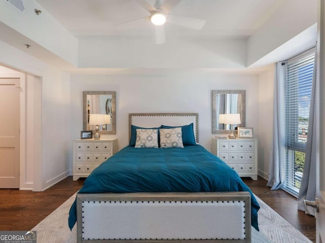 bedroom with dark hardwood / wood-style floors and ceiling fan