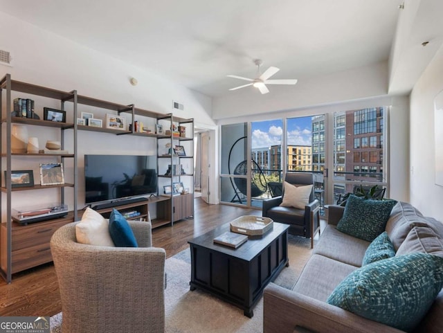 living room with hardwood / wood-style flooring and ceiling fan