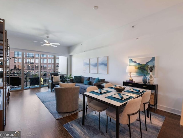 dining area featuring ceiling fan and dark hardwood / wood-style flooring