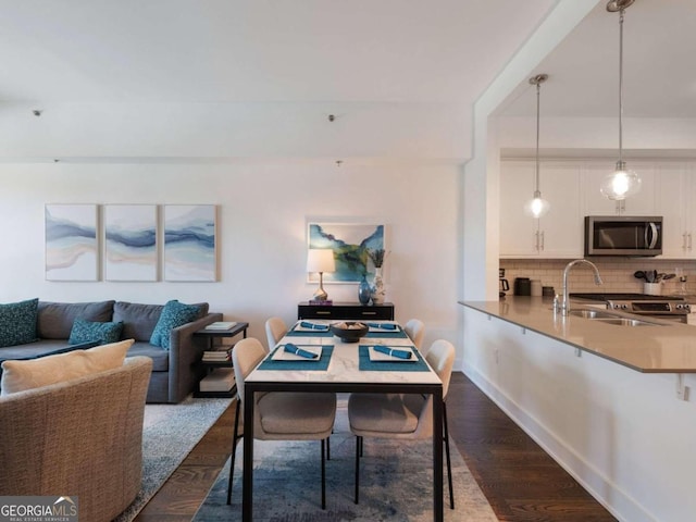 dining room featuring sink and dark hardwood / wood-style floors