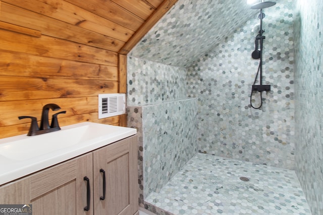 bathroom with vanity, lofted ceiling, wooden ceiling, and tiled shower