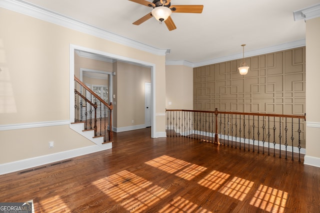 empty room featuring ornamental molding, ceiling fan, and dark hardwood / wood-style flooring